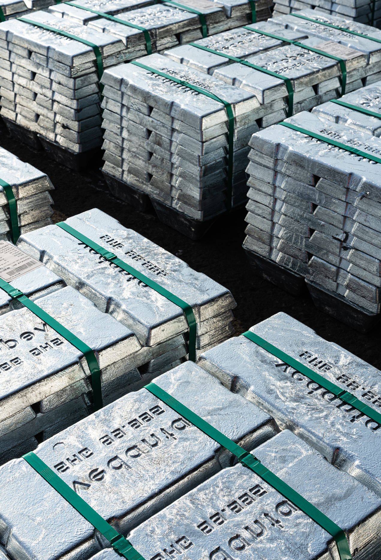 Stacked silver-zinc ingots bound with straps